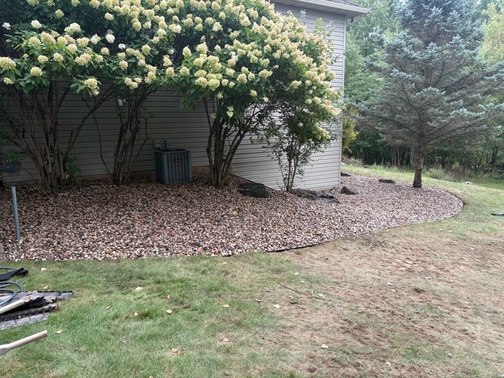 Overgrown Landscape Beds Cleaned Up with Low-Maintenance Rock image