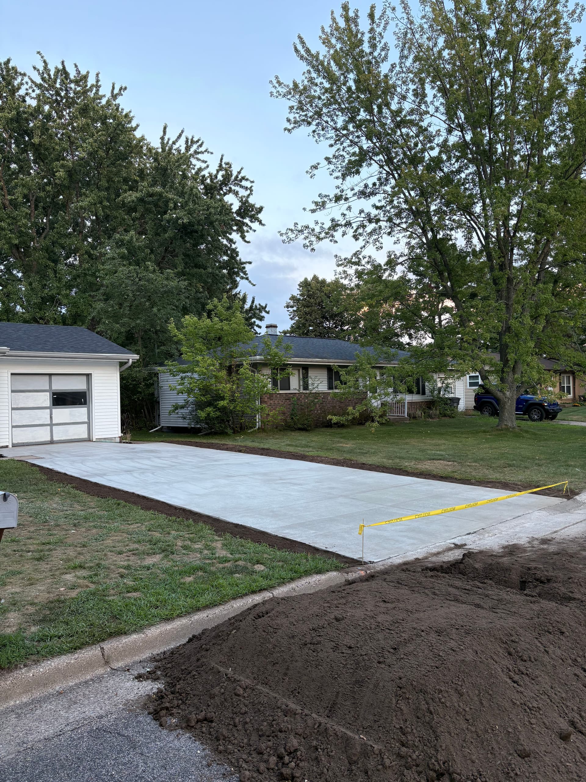 Worn-Out Asphalt Replaced With a Clean Concrete Driveway image